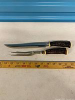 Knife and fork side by side with measuring tape