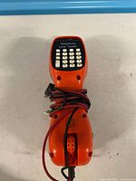 Front view showing keypad and corded leads