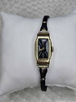 Front view showing rectangular case, dial, strap