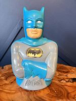 Front view of Batman piggy bank showing chest emblem and embossed name