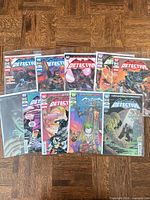 All nine Detective Comics issues laid out together, showing covers and protective bags