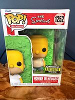 Front view of boxed Funko Pop Homer in Hedges #1252 showing Entertainment Earth exclusive sticker