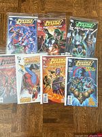 All seven bagged comic books laid out