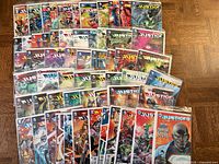All comic books spread showing Justice League run and extras