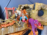 Group shot of figures Roboto, Stridor, Panthor and assorted rocky playset parts