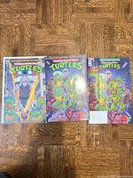 Three TMNT comics laid out face up