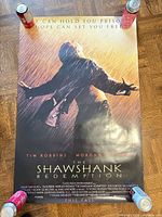 Full view of The Shawshank Redemption poster showing artwork, credits and tagline