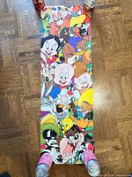 Full view of long vertical Looney Tunes poster held down at corners