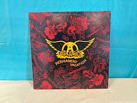 Front cover displaying Aerosmith Permanent Vacation artwork