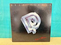 Front of Deep Purple Perfect Strangers LP sleeve showing DP metallic logo