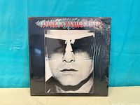 Front cover of Elton John Victim of Love vinyl in shrink wrap