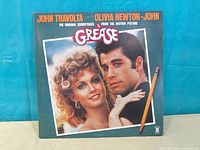 Front of gatefold jacket featuring Travolta and Newton-John