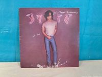 Front cover showing artist image and wear at bottom