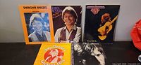 Group shot of five John Denver sheet music/songbooks