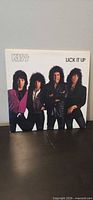 Front cover of Kiss Lick It Up album showing band photo