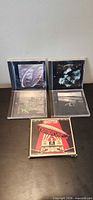 Five Led Zeppelin CD jewel cases displayed on table