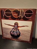 Front cover showing Decade title and guitar-case artwork