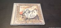 Front of jewel case showing Splendor Solis artwork and black marker autographs