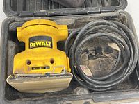 Top view of DeWalt DW411 sander inside case with cord