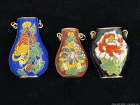All three miniature cloisonné vase pendants on black background