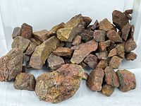 pile of assorted rough jasper stones on tray