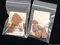 Two plastic bags with multiple rough poppy jasper stones