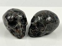 Front and side view of both carved stone crystal skulls