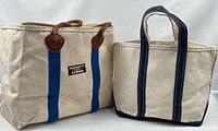 Front view of both LL Bean canvas tote bags showing size difference, logo, straps and handles