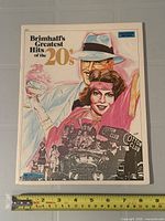 Front cover of Brimhall's Greatest Hits of the 20's booklet with ruler for scale
