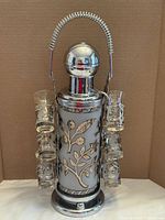 Full view of liquor pump dispenser with attached shot glasses