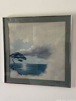 Full view of framed seascape painting on wall