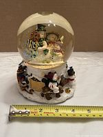 Full front view of snow globe with tape measure for scale