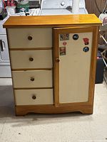 Front view showing four drawers and single door wardrobe compartment