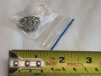 Pin beside measuring tape indicating ~1 inch width