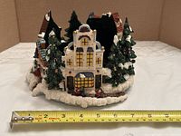 Front view showing village scene and tape for width measurement