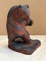 front angled view of carved wood bear figure