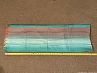 Full view of scarf with tape measure showing overall length