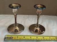 Both candlesticks with tape measure showing height and base size