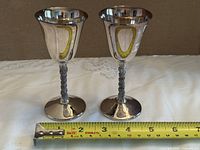 Pair of sherry goblets with tape measure showing diameter