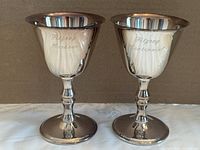 Front view of both goblets showing engravings
