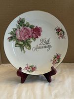 Front view of SAJI 25th Anniversary plate on stand