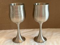 Front view of both pewter goblets showing engraving on left piece