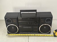 Front view showing main unit and two detachable speakers