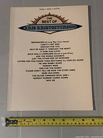 Front cover showing title, instrumentation and song list with ruler for scale