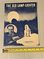 Front cover of The Old Lamp-Lighter sheet music with ruler for scale