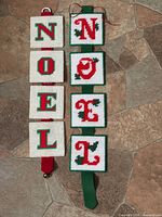 Both NOEL decorations laid out side by side showing full length