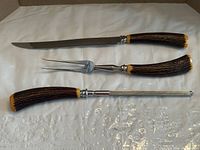 Full view of knife, fork and sharpening steel showing handles and stainless components