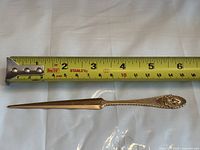 Letter opener beside tape measure showing approx 8.25 in length