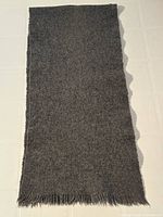 full view of charcoal gray wool scarf laid flat