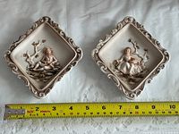 both plaques side by side with tape measure showing size